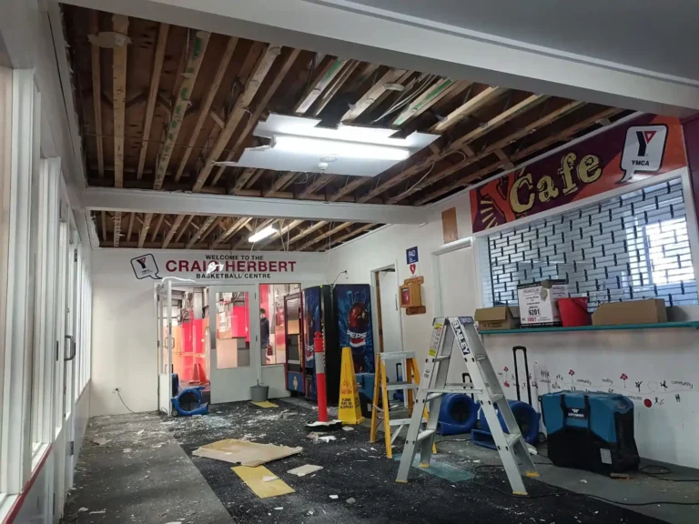 Commercial property in Geelong with flood-damaged ceiling and floor showing mould growth, requiring professional flood restoration and mould remediation