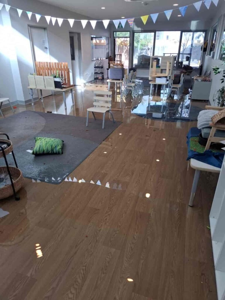 Emergency flood restoration at a Geelong childcare facility with Flood Restoration Geelong team extracting water and drying flooded floors