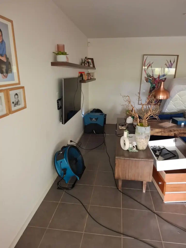 Flood restoration in a Geelong home with professional technicians restoring water-damaged floors and interiors