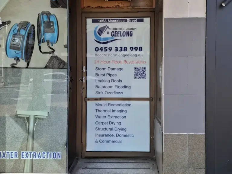 Flood Restoration Geelong storefront door displaying company logo and service detail stickers for 24/7 flood and water damage restoration services