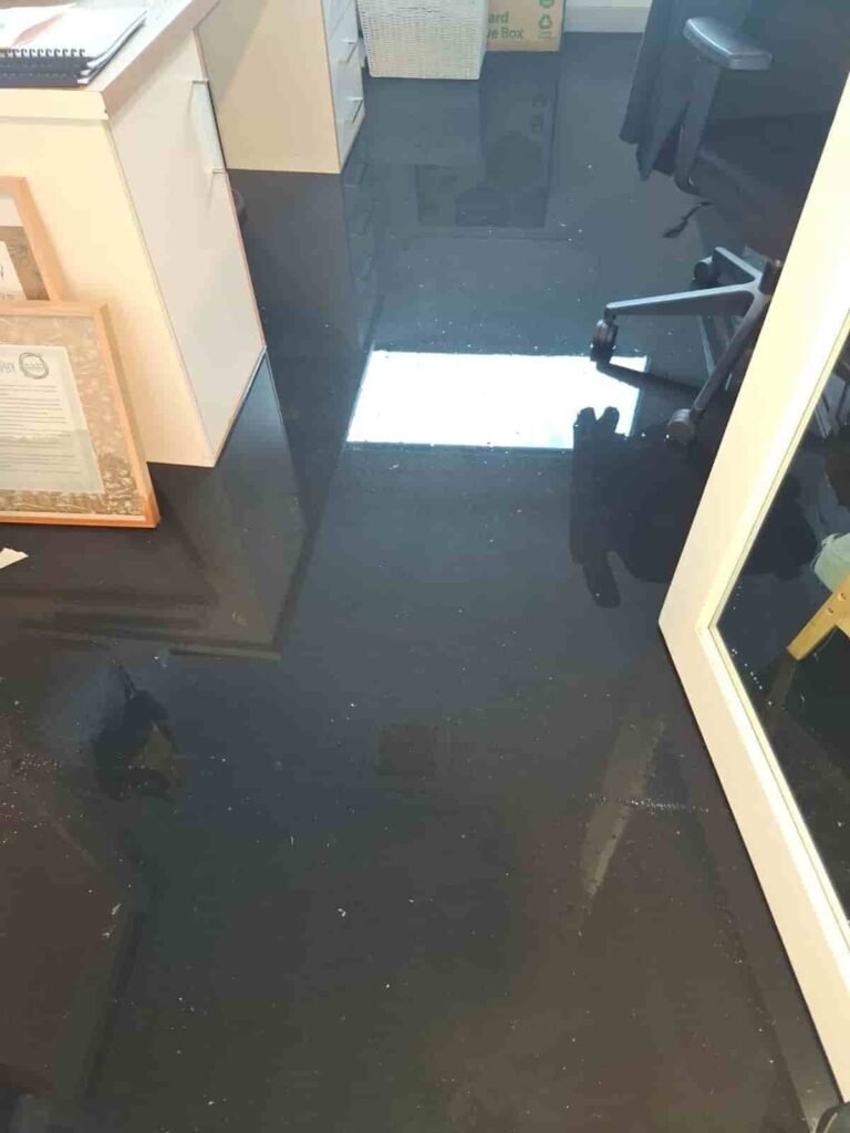 Flooded office interior in Geelong with standing water across the floor, showing commercial water damage requiring urgent flood restoration